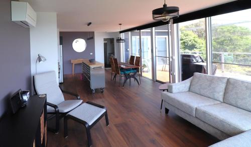 a living room with a couch and a table at 4 Scenic Court in Mallacoota