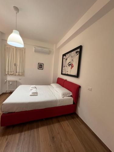 a bedroom with a red bed in a room at Il Violino in Florence