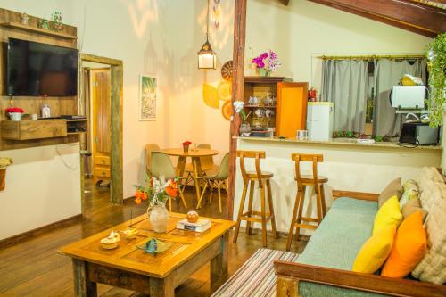 a living room with a couch and a table at CHALÉ ADOBE in Carrancas