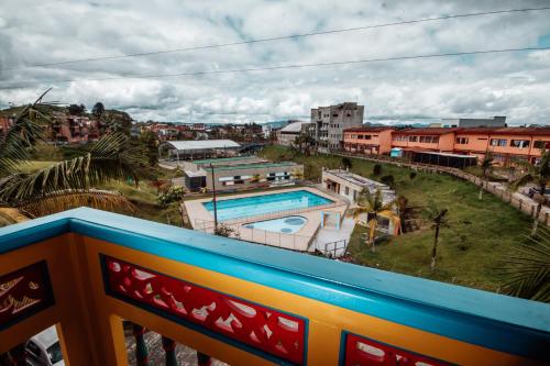 a view of a pool from a balcony at Las Palmas Apartamentos Guatapé in Guatapé