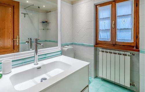 a white bathroom with a sink and a mirror at Beautiful Apartment In Monte San Savino With Kitchen in Monte San Savino