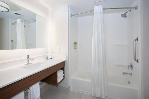 a white bathroom with a shower and a sink at Holiday Inn Express Yreka-Shasta Area by IHG in Yreka