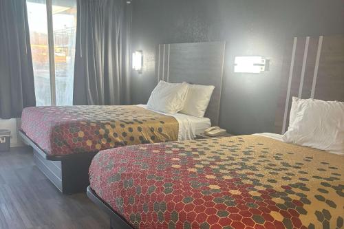 una camera d'albergo con due letti e una finestra di Econo Lodge Calhoun South a Calhoun