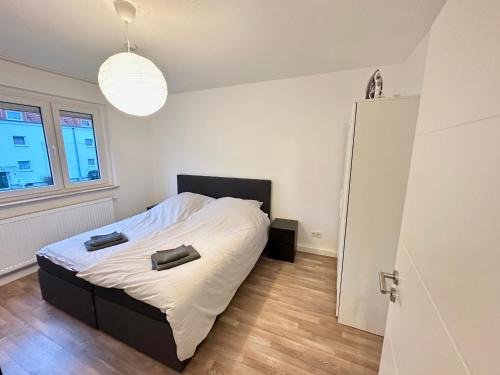 a bedroom with a bed with two bags on it at Modern 2 Bedroom Apartment near train station in Eichwäldchen