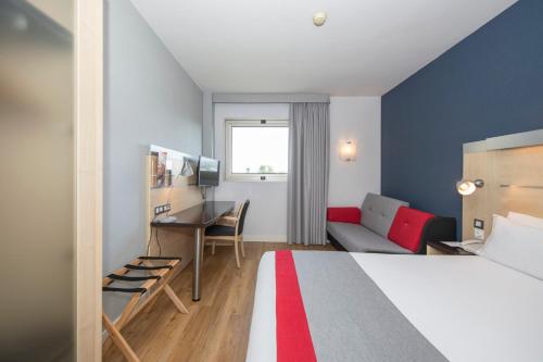 a hotel room with a bed and a desk at Holiday Inn Express Barcelona - Montmeló by IHG in Granollers
