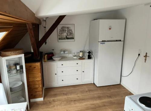 a kitchen with a white refrigerator in a room at İnci in Hamburg