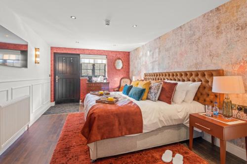 a bedroom with a large bed and a table at The Ley Arms in Exeter