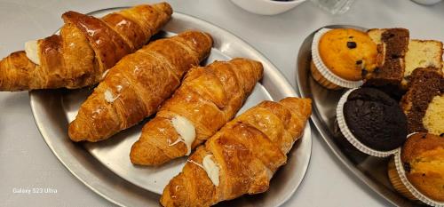 a plate of pastries and bread on a table at Adac Boutique Hotel in Bucharest
