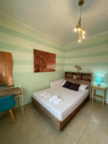 a bedroom with a bed with two towels on it at Apartment Nina Holidays in Paralia Sikias