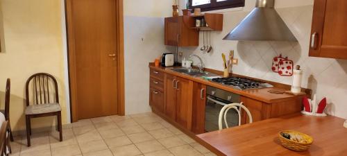 una cucina con armadi in legno e piano cottura. di Dimora Nonna Angela ad Alberobello