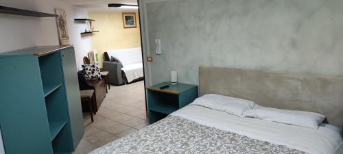 a bedroom with a bed with a blue cabinet at Dimora Nonna Angela in Alberobello