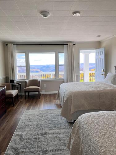 a bedroom with two beds and a large window at Blue Vista Motor Lodge in Florida
