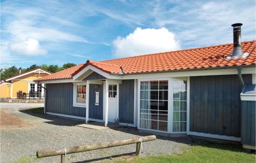 a small house with an orange roof at Marina Fiskenæs Feriepark in Gråsten