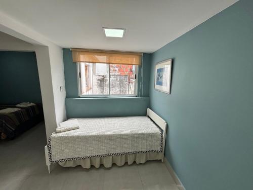 a small bedroom with a bed and a window at Atelier- Bohardilla a 2 cuadras de la plaza principal in Salta