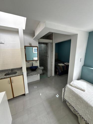 a bathroom with a sink and a bed in a room at Atelier- Bohardilla a 2 cuadras de la plaza principal in Salta