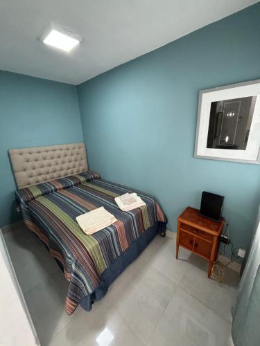 a bedroom with a bed and a table and a window at Atelier- Bohardilla a 2 cuadras de la plaza principal in Salta