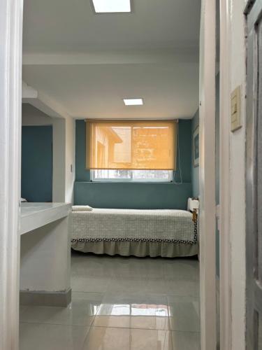 a small room with a bed and a window at Atelier- Bohardilla a 2 cuadras de la plaza principal in Salta