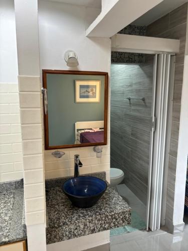 a bathroom with a sink and a mirror at Atelier- Bohardilla a 2 cuadras de la plaza principal in Salta