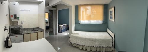 a small room with a bed and a sink at Atelier- Bohardilla a 2 cuadras de la plaza principal in Salta