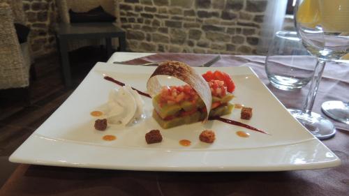 a white plate with a sandwich on a table at Hotel du Golf de Clécy in Clécy