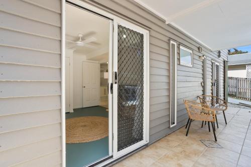 a screened porch with a chair and a sliding glass door at Urban Apartment in the Heart of Paddington in Brisbane