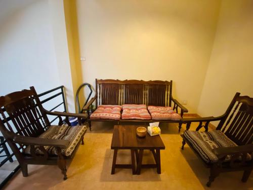 a room with chairs and a couch and a table at PIA homestay - Tours & Motorbike rentals - Cao Bằng in Cao Bằng