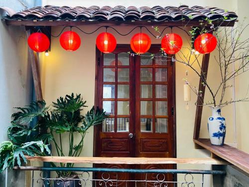 a group of red lanterns in front of a door at PIA homestay - Tours & Motorbike rentals - Cao Bằng in Cao Bằng