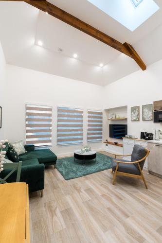 a living room with a couch and a table at Deansgate Luxury Apartments in Manchester