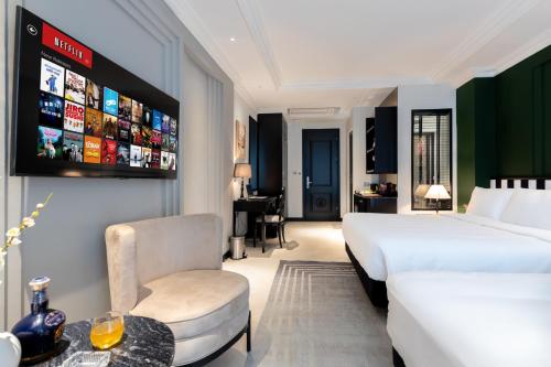 a hotel room with a bed and a chair at SWORD LAKE Hotel in Hanoi