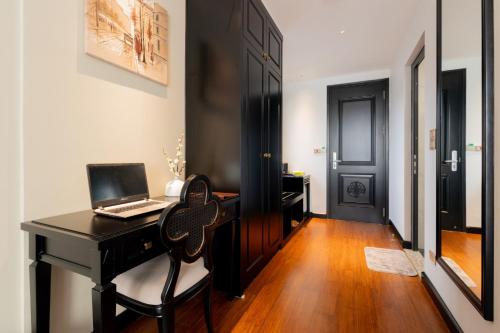 a room with a desk with a laptop on it at SWORD LAKE Hotel in Hanoi