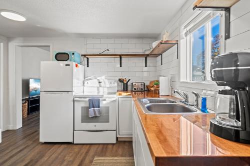 a kitchen with a white refrigerator and a sink at Southern Oregon Gem in Medford