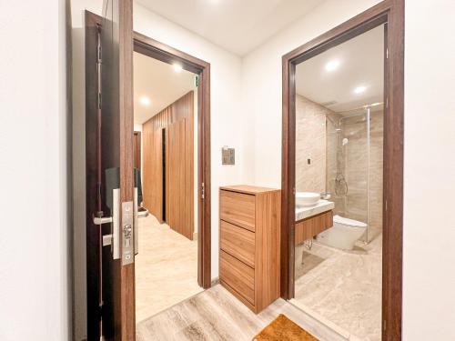 a bathroom with a toilet and a sink and a mirror at DA NANG BAY HOTEL in Danang