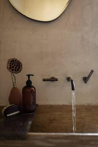 a sink with water coming out of a faucet at SABI Award Winning Designer Cabin in Binalong Bay