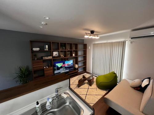 a living room with a sink and a couch and a television at 360stay - Vacation STAY 18091v in Hagi
