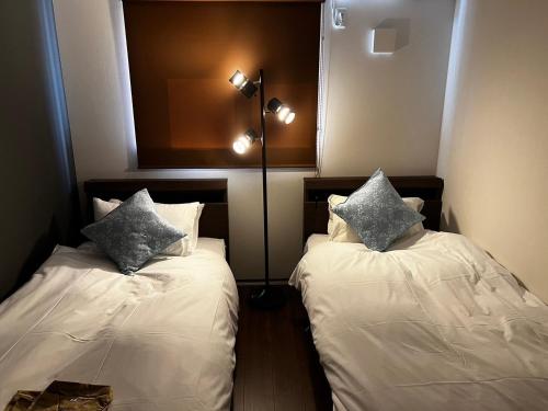 萩市にある360stay - Vacation STAY 18091vのベッド2台(枕付)が備わる客室です。