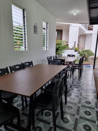 a row of tables and chairs in a room at The Boathouse at Calatagan in Sipating
