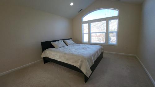 a bedroom with a bed with a large window at Family friendly home, amazing view in Dallas