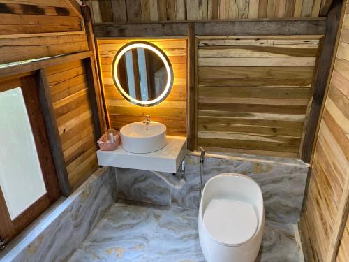 a bathroom with a toilet and a sink at Green Bamboo Lodge Resort in Cat Tien