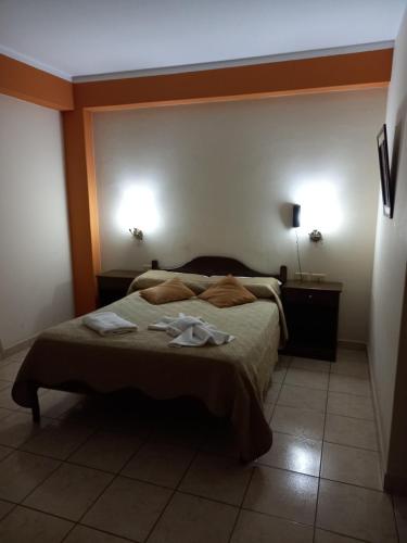 a bedroom with a bed with two towels on it at Hotel Andalucia in Salta