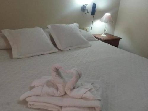 two swans made out of towels on a bed at Hotel Andalucia in Salta