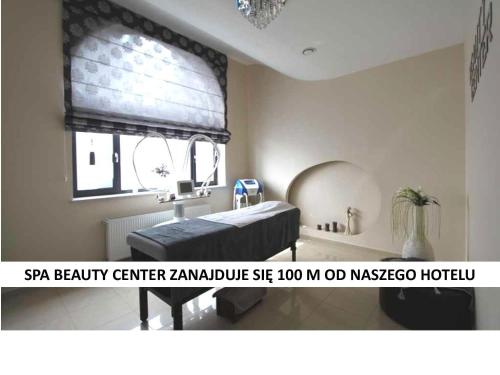 a room with a bed and a sink and a window at Aviator Hotel Restauracja & SPA in Pabianice