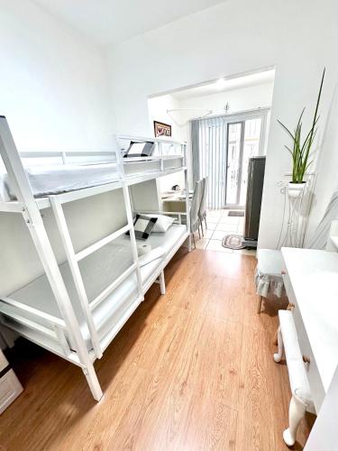 a room with two bunk beds and a desk at Casa Râgés - Condo Style, Studio Type Room in Lancaster New City Zone 1 in Imus