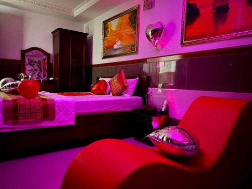 a room with two beds with pink lighting at Gia Hân Hotel in Ho Chi Minh City