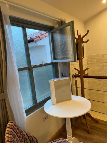 a laptop sitting on a table in front of a window at Adamas House Hotel Boutique in Quito