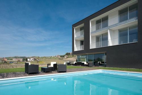 a building with a swimming pool in front of a building at House Iaquin in Dobrovo