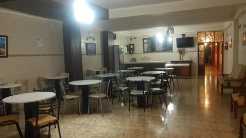 a room with tables and chairs in a restaurant at Hotel Andalucia in Salta