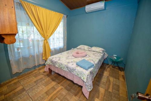 a bedroom with a bed in a room with a window at Casa Encanto in Puntarenas