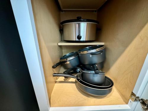 a kitchen with pots and pans on a shelf at Superb Home 7 minutes from Lackland Air Force Base in San Antonio