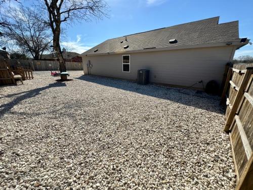 a garage with a fence and a building at Superb Home 7 minutes from Lackland Air Force Base in San Antonio