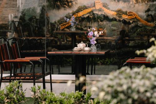 a table with a vase of flowers on it at Diamond Hotel in Hai Phong